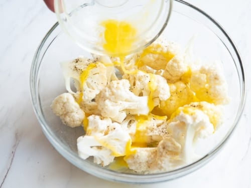 adding egg to cauliflower florets