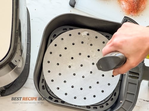 spraying oil on perforated paper