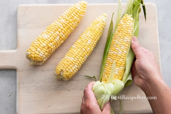 Shucking corn ears