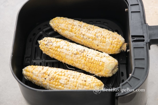 Uncooked corn in air fryer basket