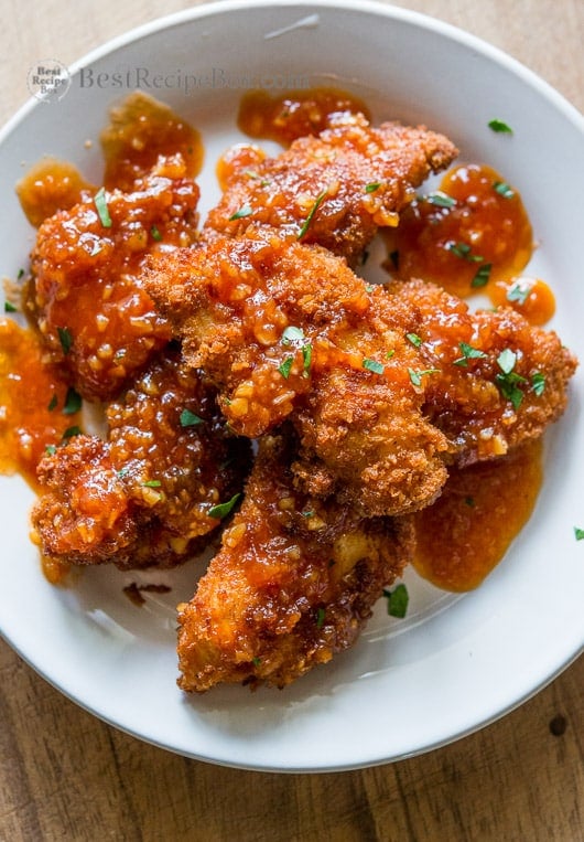 Juicy chicken strips or chicken tenders recipe on a plate 