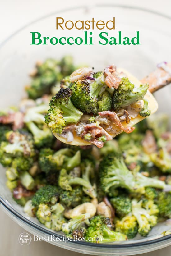 Roasted Broccoli Salad Recipe with Bacon, Nuts and Dried Fruit in a bowl with spatula 