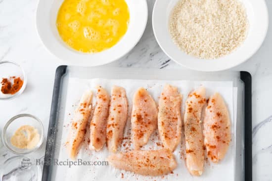 Cut chicken tenders and season with spices
