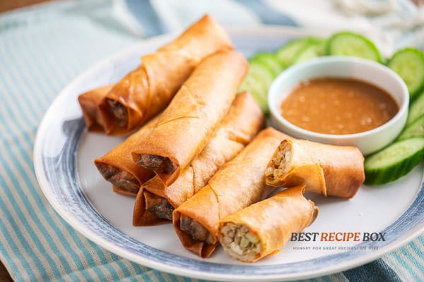 Finished egg rolls on plate with sauce