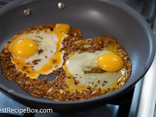 Raw eggs in pan with chili crisp