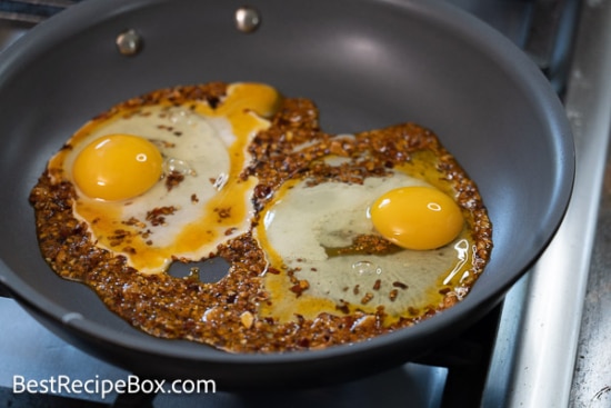 Raw eggs in pan with chili crisp