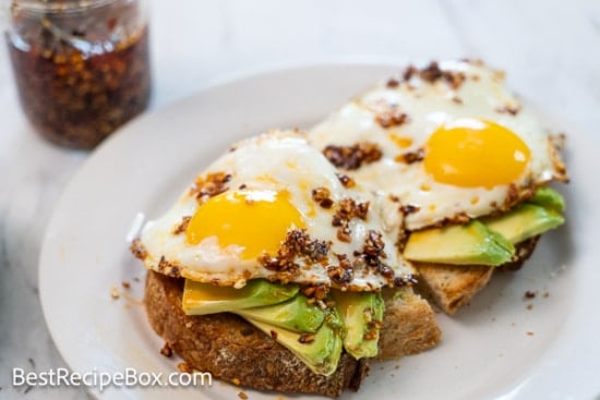 Cooked eggs on toast with avocado