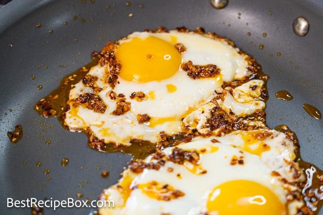 fried eggs with chili crisp in pan 