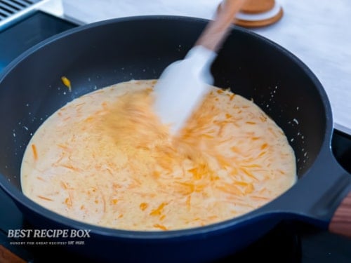 stirring to melt cheese