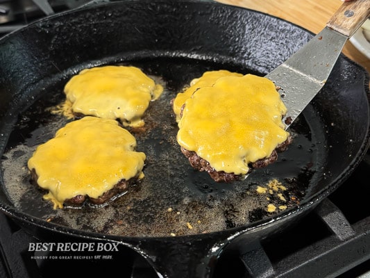 cheese on top of burger patties