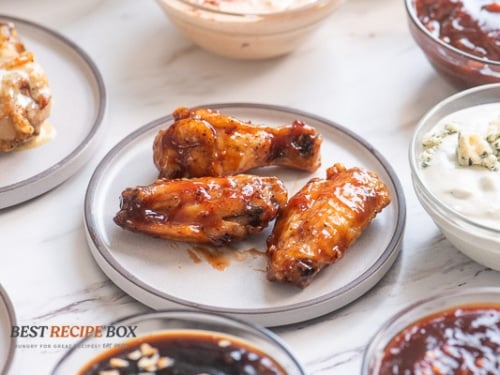 Wings tossed with sauce on a plate