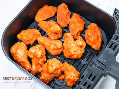 Half cooked sriracha wings in air fryer