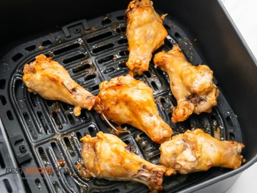 Fully cooked chicken wings in air fryer basket