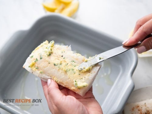 rubbing butter over the fish