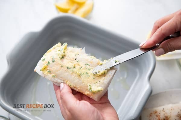 rubbing butter over the fish