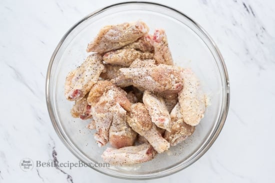 Raw chicken wings seasoned with salt and pepper