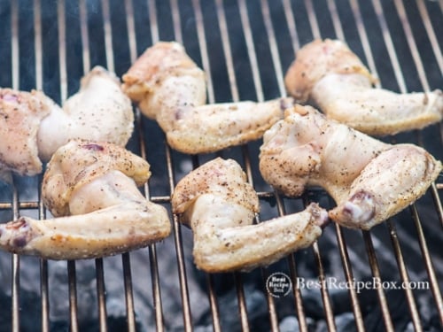Half cooked chicken wings on the grill