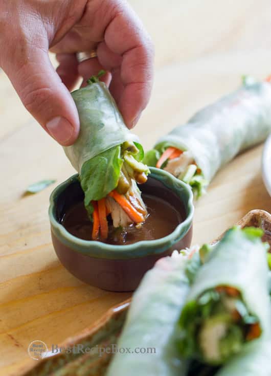 Hoisin Peanut Butter Dip Recipe for Spring Rolls, Egg Rolls, Dumplings on a cutting board with dipping sauce