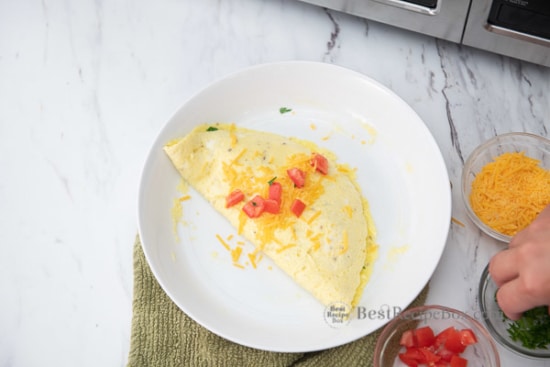 Omelette with cheese and tomato on top