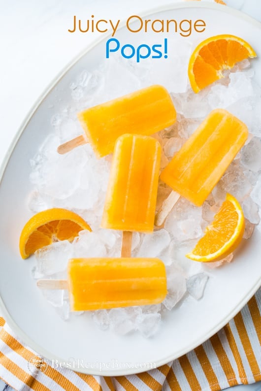 Juicy Orange Popsicles Recipe on a plate of ice