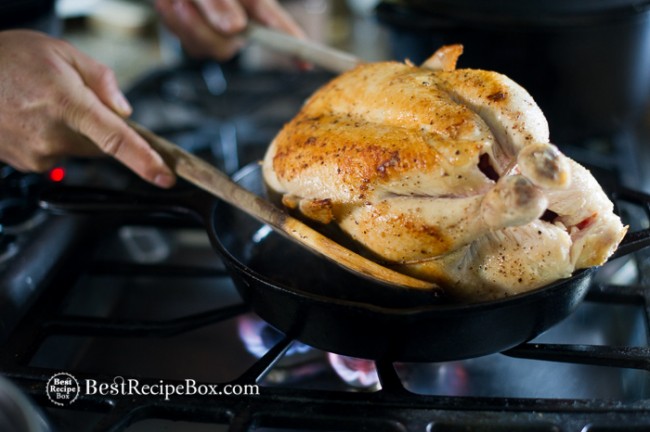Whole chicken with skin mostly browned in cast iron