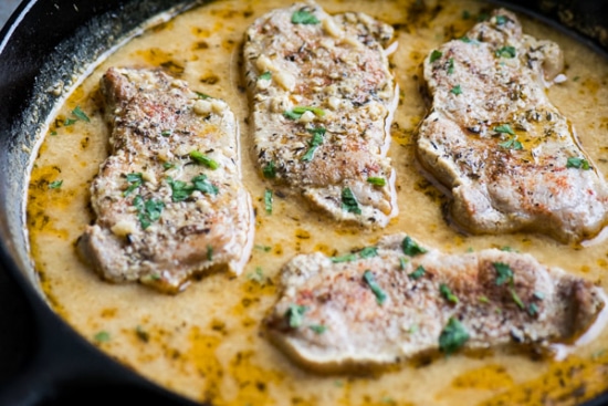 Baked pork chops and sauce in skillet