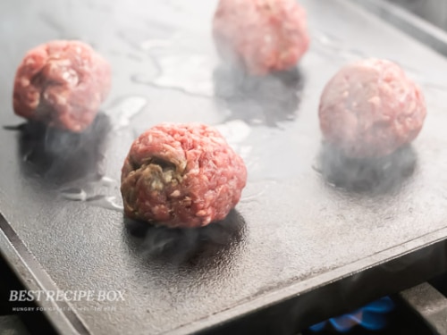 balls of beef on skillet flat top