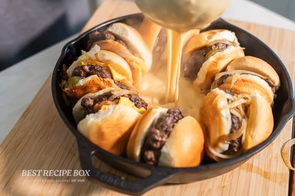 pouring hot cheese sauce into slider pan