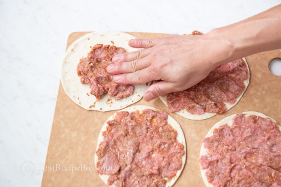 spreading meat over tortilla