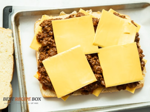 Extra cheese added on top of sloppy joe mix