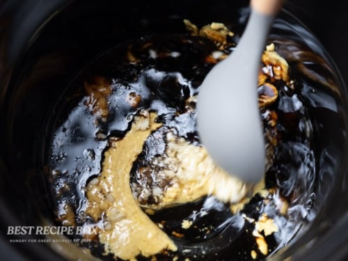 slow cooker honey mustard chicken ingredients being stirred