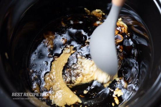slow cooker honey mustard chicken ingredients being stirred