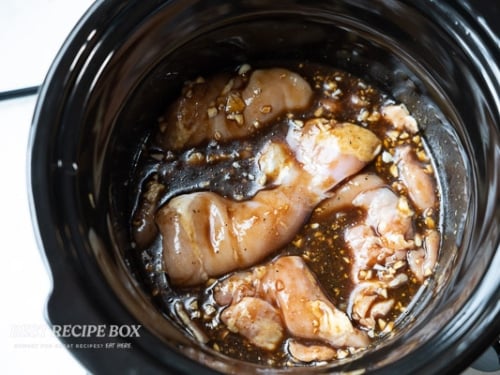 chicken added to the pot of slow cooker honey mustard chicken