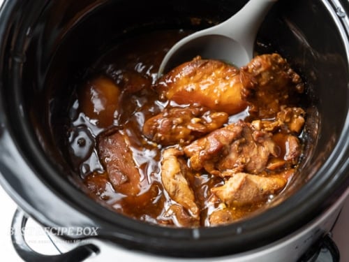 cooked slow cooker honey mustard chicken with spoon