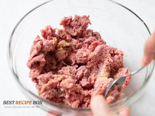 Seasoning beef in a bowl