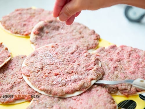 Sprinkling salt on top of meat
