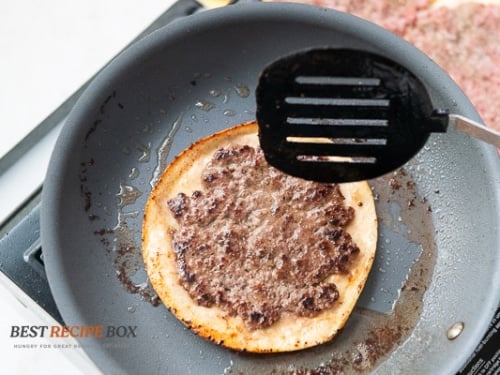Tortilla meat side up in pan