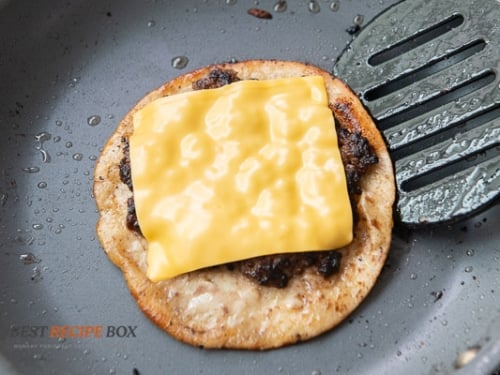 Cheese slice melted on top of meat