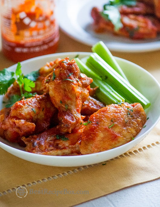 Healthier Sriracha Chicken Wings loaded with flavor, less fat on a plate 