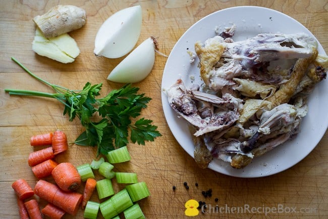 Chicken bones and vegetables on cutting board