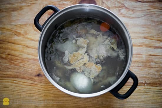 chicken and vegetables simmering in a pot of water