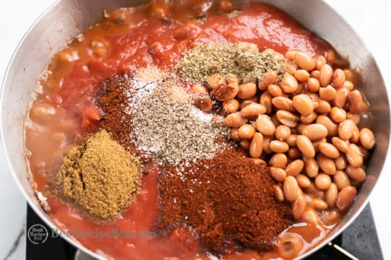 Add tomato sauce and spices with beans