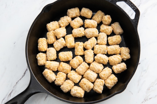 Frozen tater tots in a skillet