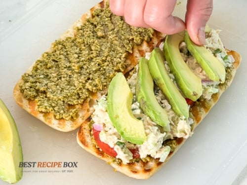 Adding ingredients to sandwich
