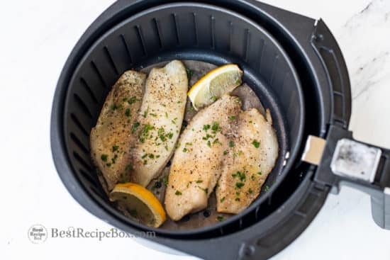 Cooked white fish or tilapia in air fryer basket
